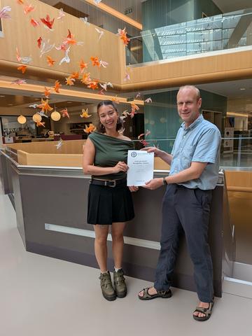 Ayaka Hogg receives her award from Associate Professor Mark Roberts